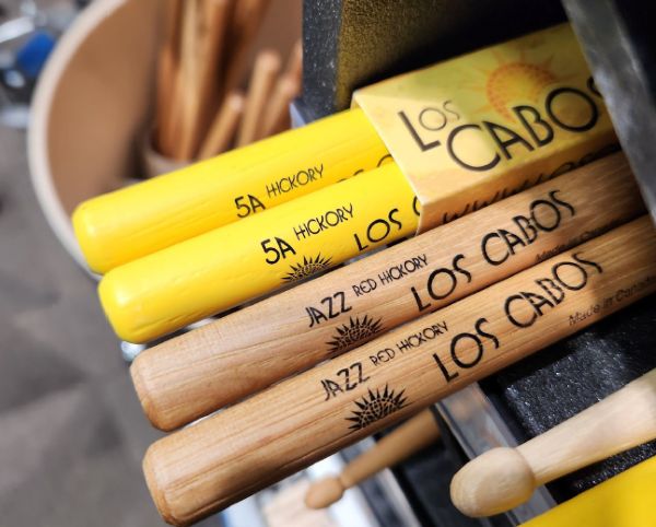 2 Pairs of drumsticks one with rubber coating another with lacquer finish