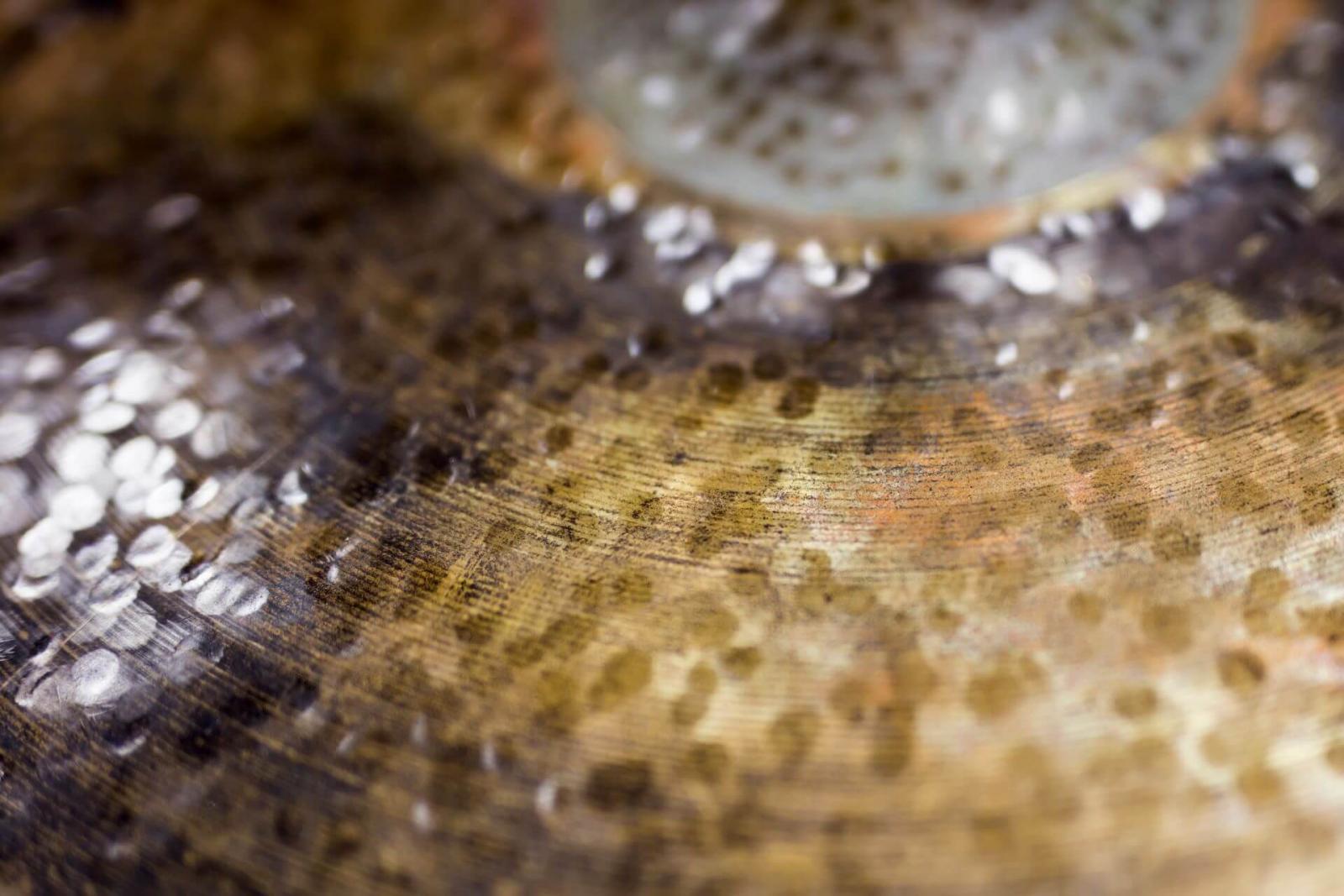 A close-up of a dirty cymbal