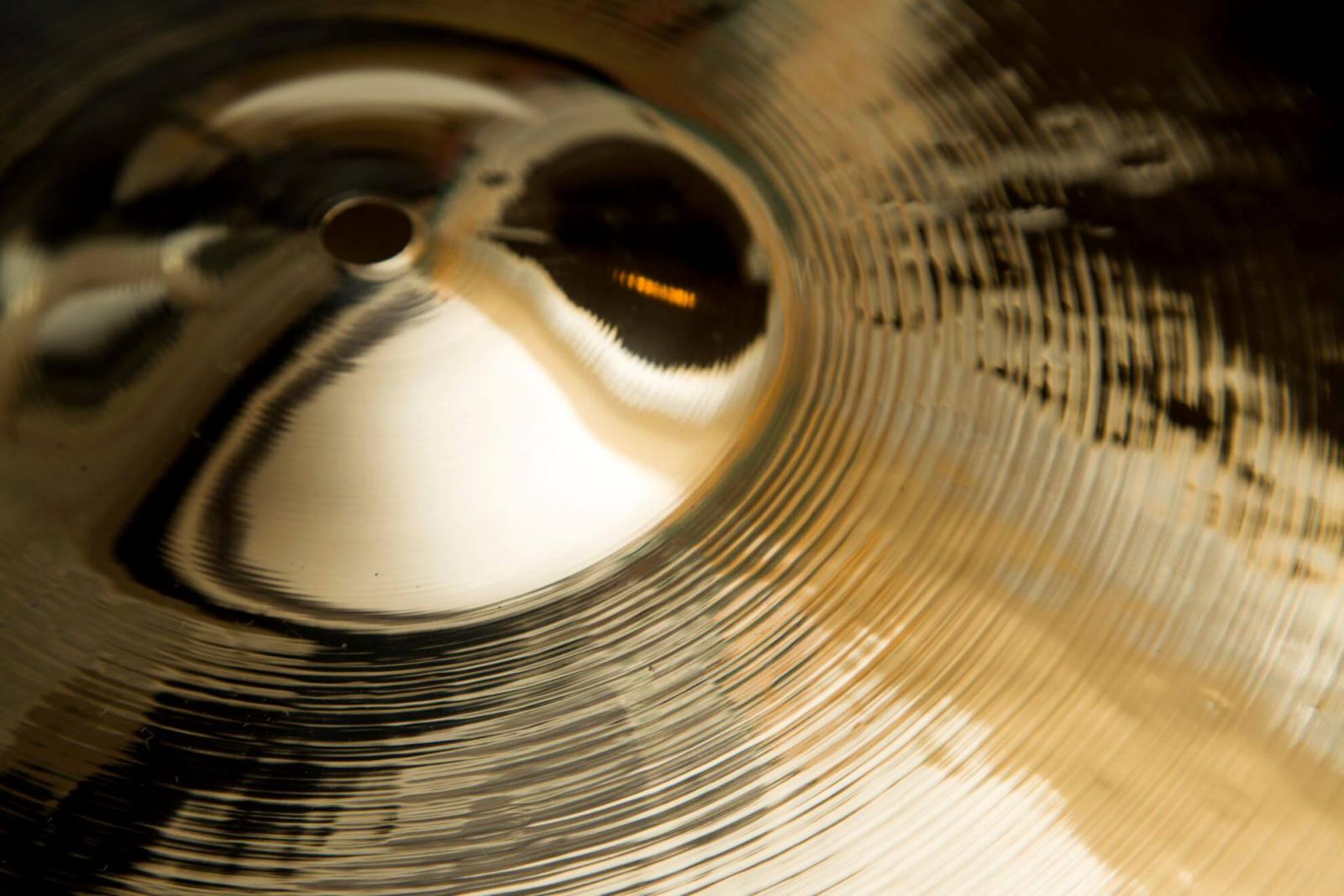 A cymbal with a reflective finish after being polished and cleaned