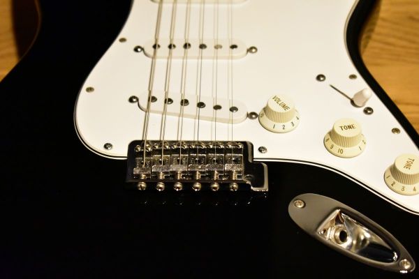 Black electric guitar with a single-coil pickup