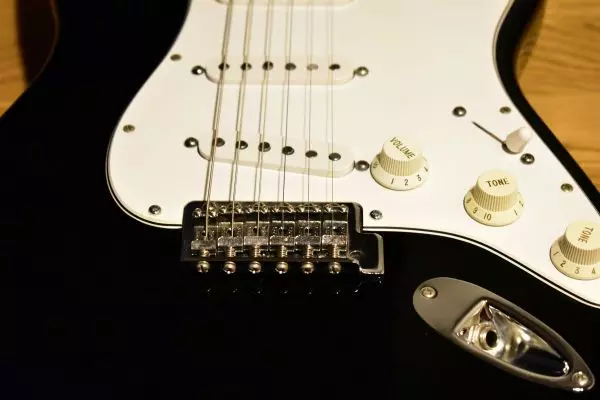 Black electric guitar with a single-coil pickup