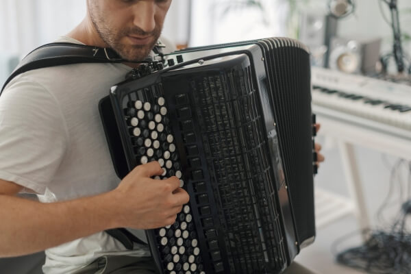 man playing the Accordion in his living room