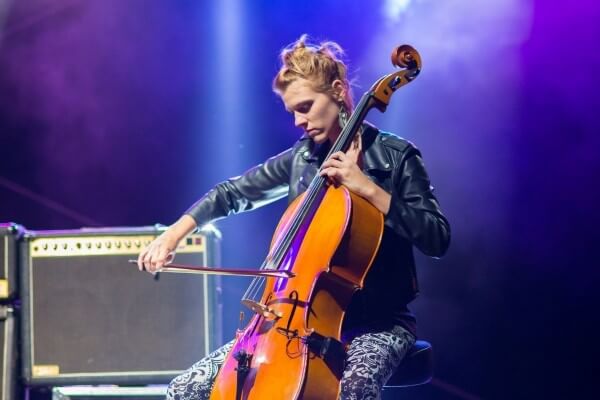 Female performing while playing the Cello