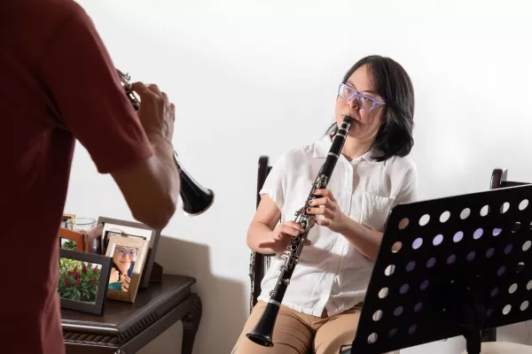 woman taking clarinet lessons with a teacher