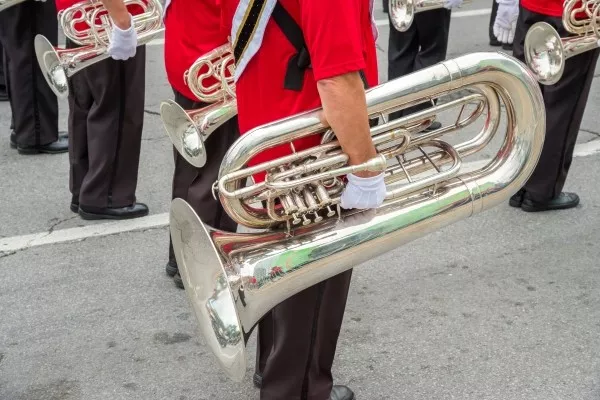 A man playing the Euphonium outside in the city street