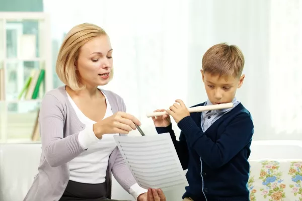 A child taking Flute lessons with an instructor