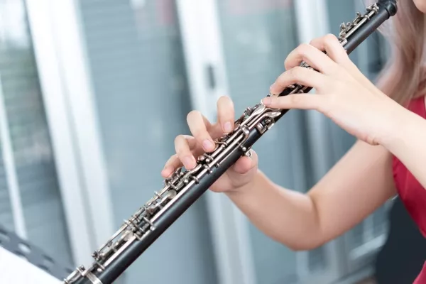 A close up of a female playing the oboe