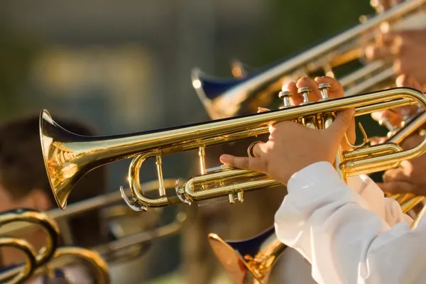 A zoomed side view image of a trumpet being used during a band