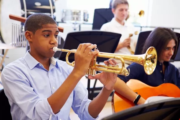 A student in school playing the trumpet