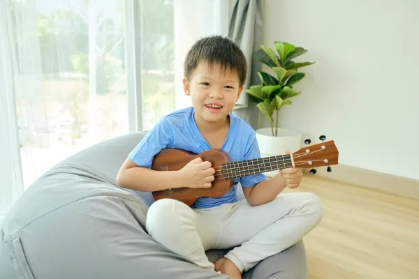 A student in school playing the Ukulele