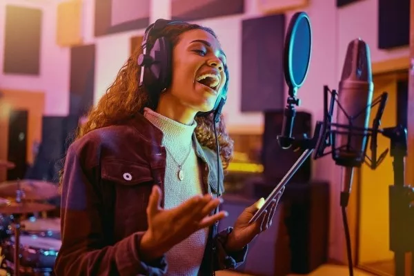 Woman singing in a recording studio