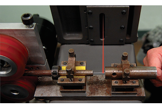 Laser guitar string manufacturing device